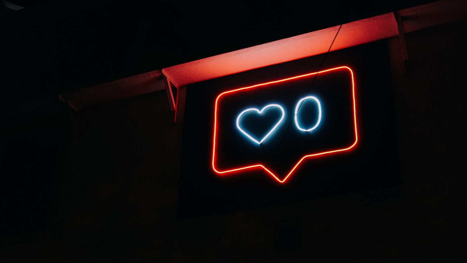 Photo of a neon sign showing a love heart and the number zero